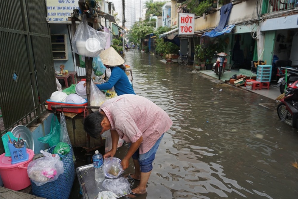 Nhiều hẻm trên đường Nguyễn Xí ngập sâu. Đến hơn 10h sáng, nước vẫn chưa rút, nhiều người dân vẫn quay cuồng trong biển nước.