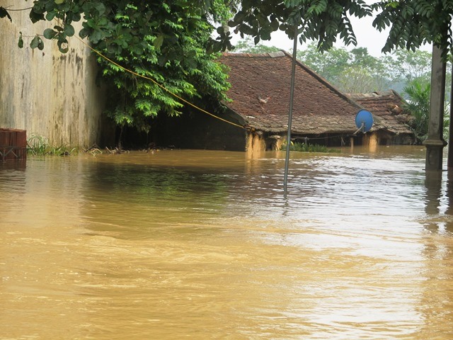 Đến chiều 13.10, dù nước đã rút nhưng tuyến giao thông huyết mạch vẫn bị cô lập, hàng nghìn ngôi nhà ở đang chìm trong nước. (Ảnh: HT)