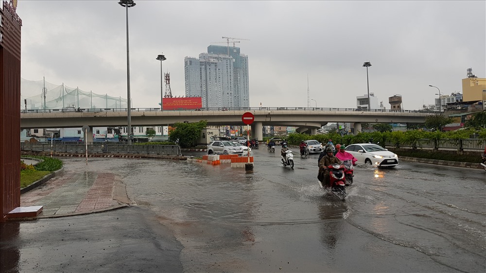 Nước triều từ cống tràn ra đường Nguyễn Hữu Cảnh khiến nước đổ về trước khu Saigon Pearn rất nhiều. Ảnh: Trường Sơn