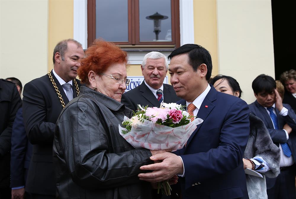 Phó Thủ tướng Vương Đình Huệ tặng hoa bà Froda người vinh dự được tặng hoa Chủ tịch Hồ Chí Minh khi Người tới thăm thị trấn. Ảnh: Thành Chung