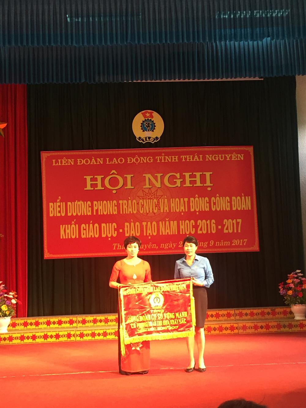 Đồng chí Trịnh Thanh Hằng trao cờ của Tổng LDDLDDVn cho CĐCS Trường THCS Quy Kỳ huyện Định Hóa. Ảnh: Đ.T