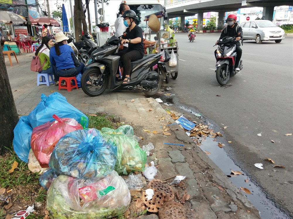 Tại tuyến đường Điện Biên Phủ (quận Bình Thạnh), các gốc cây, trụ điện, biển báo trở thành những điểm tập kết rác bất đắc dĩ từ các hộ dân trước khi rác được thu gom.