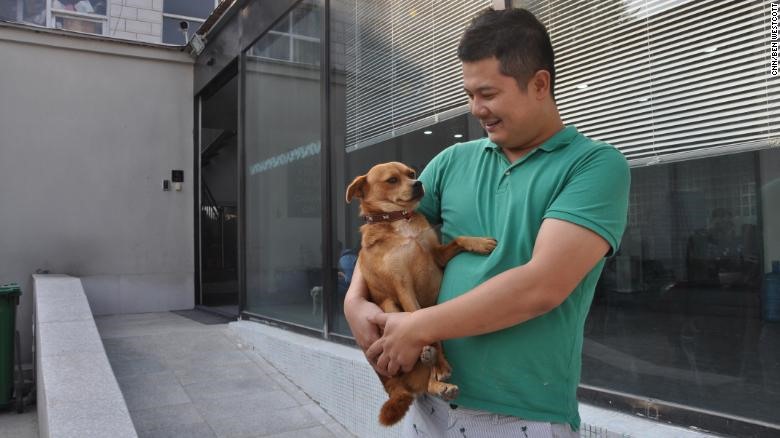 Li Chao, người sáng lập nhà tang lễ Joypets, cùng chó cưng của mình ở nơi làm việc tại Bắc Kinh. Ảnh: CNN