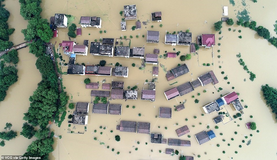 Một cảnh trên không của những ngôi nhà và đất nông nghiệp chìm trong nước lũ ở thị trấn Mawei ở Fuzhou, tỉnh Giang Tây hôm thứ Tư. Thậm chí còn có nhiều mưa hơn, camera quan sát của đài truyền hình nhà nước cho biết hôm nay, sau khi lượng mưa trung bình ở các khu vực bị ảnh hưởng trong tuần này được ghi nhận là cao hơn 51% so với các giai đoạn tương ứng của những năm trước và lớn nhất kể từ năm 1961.