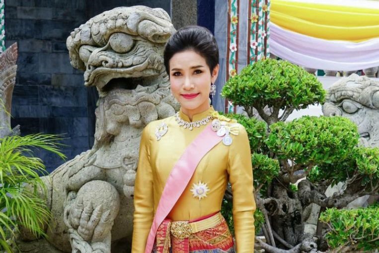 Trong một số bức ảnh, Hoàng quý phi Sineenat mặc trang phục truyền thống của Thái Lan và ngồi dưới chân nhà vua. Ảnh: TRO/AFP