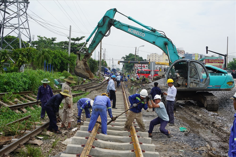 Hàng chục công nhân gấp rút đấu nối đường ray cũ vào đường ray mới phía quận Bình Thạnh và Thủ Đức.