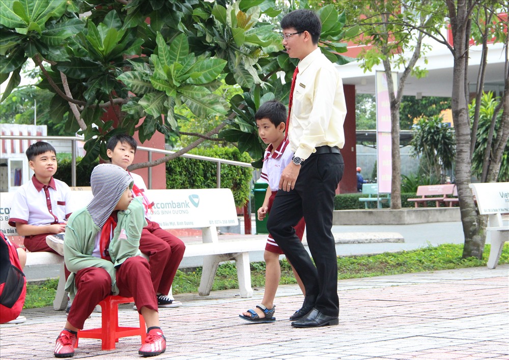 Thầy giáo tại trường Ngô Thời Nhiệm dẫn Phú Vỹ vào lớp học.