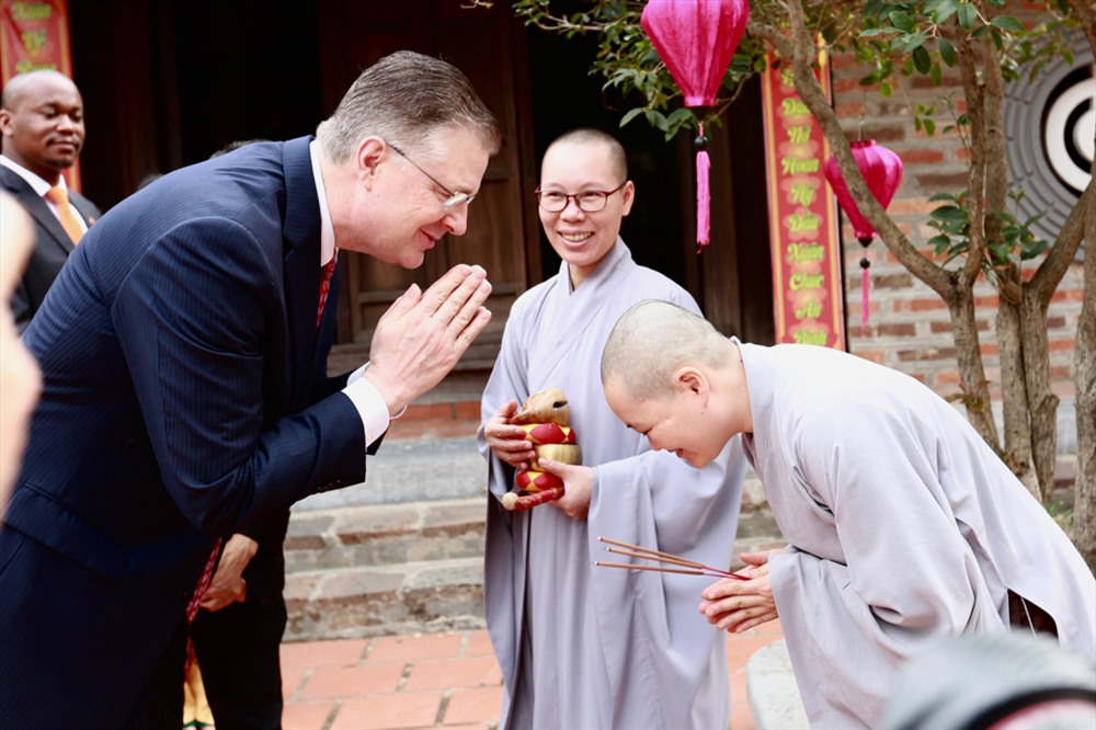 Đại sứ Mỹ tại Việt Nam Daniel J. Kritenbrink chào các sư trong chùa Kim Liên trước khi bắt đầu lễ tiễn ông Công ông Táo. Ảnh: Hải Nguyễn
