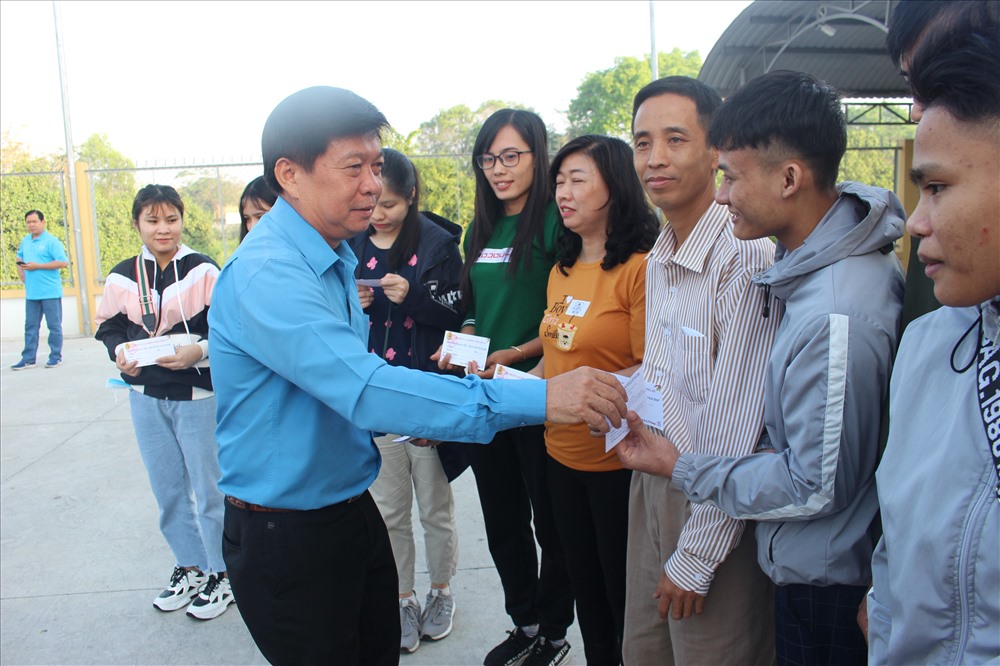 Chủ tịch LĐLĐ tỉnh long An - ông Nguyễn Văn Quí - trao vé xe cho CNLĐ về quê đón Tết. Ảnh: K.Q