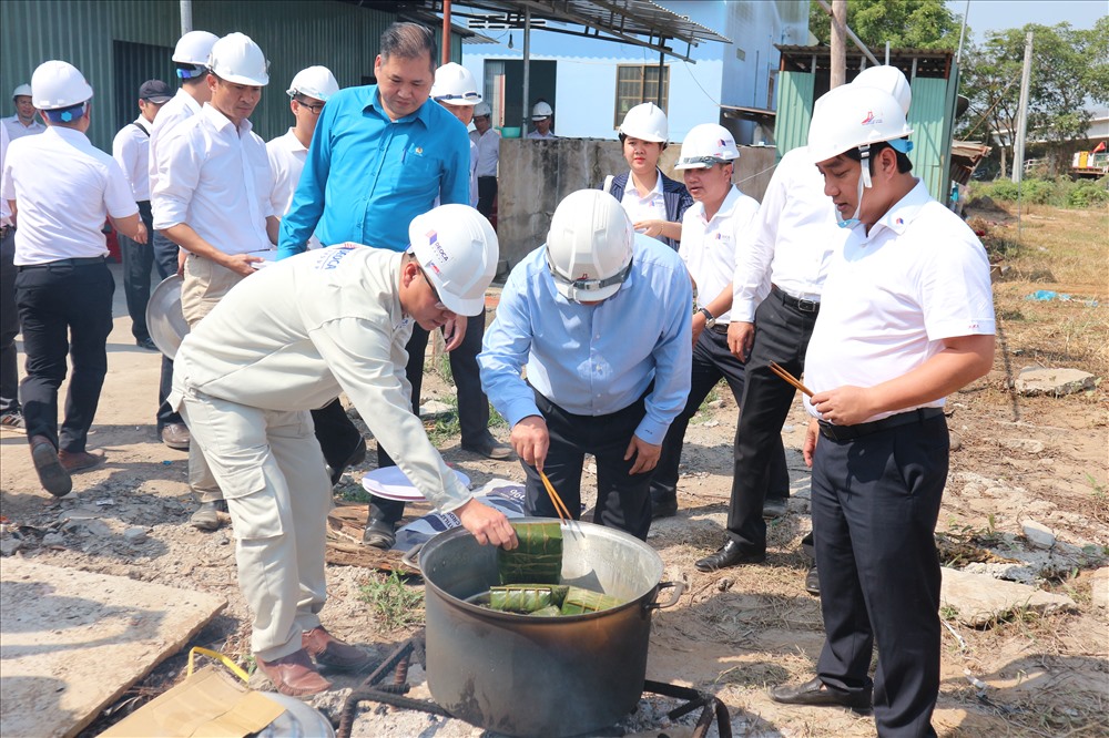 Đồng chí Nguyễn Minh Dũng xem CNLĐ nấu bánh tét chuẩn bị đón Tết trên công trình. Ảnh: K.Q