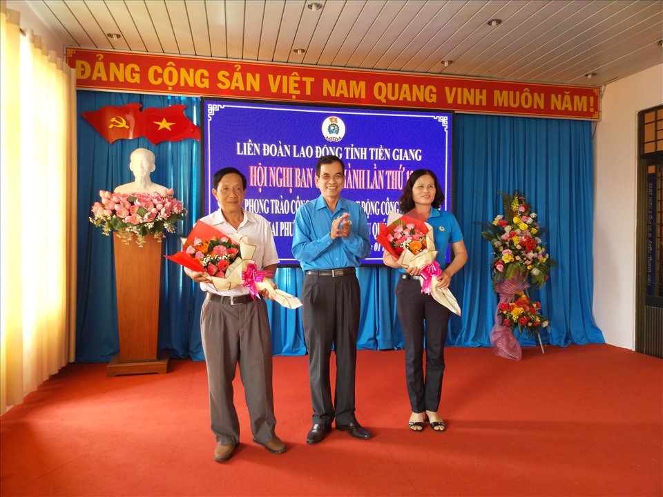 Ông Trương Văn Hiền - Chủ tịch LĐLĐ tỉnh Tiền Giang - tặng hoa cho các cựu ủy viên BCH mới nghỉ hưu. Ảnh: K.Q