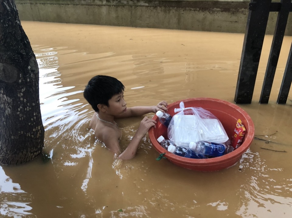 Một bạn nhỏ ở xã Triệu Thuận, huyện Triệu Phong, tỉnh Quảng Trị lội trong nước lũ