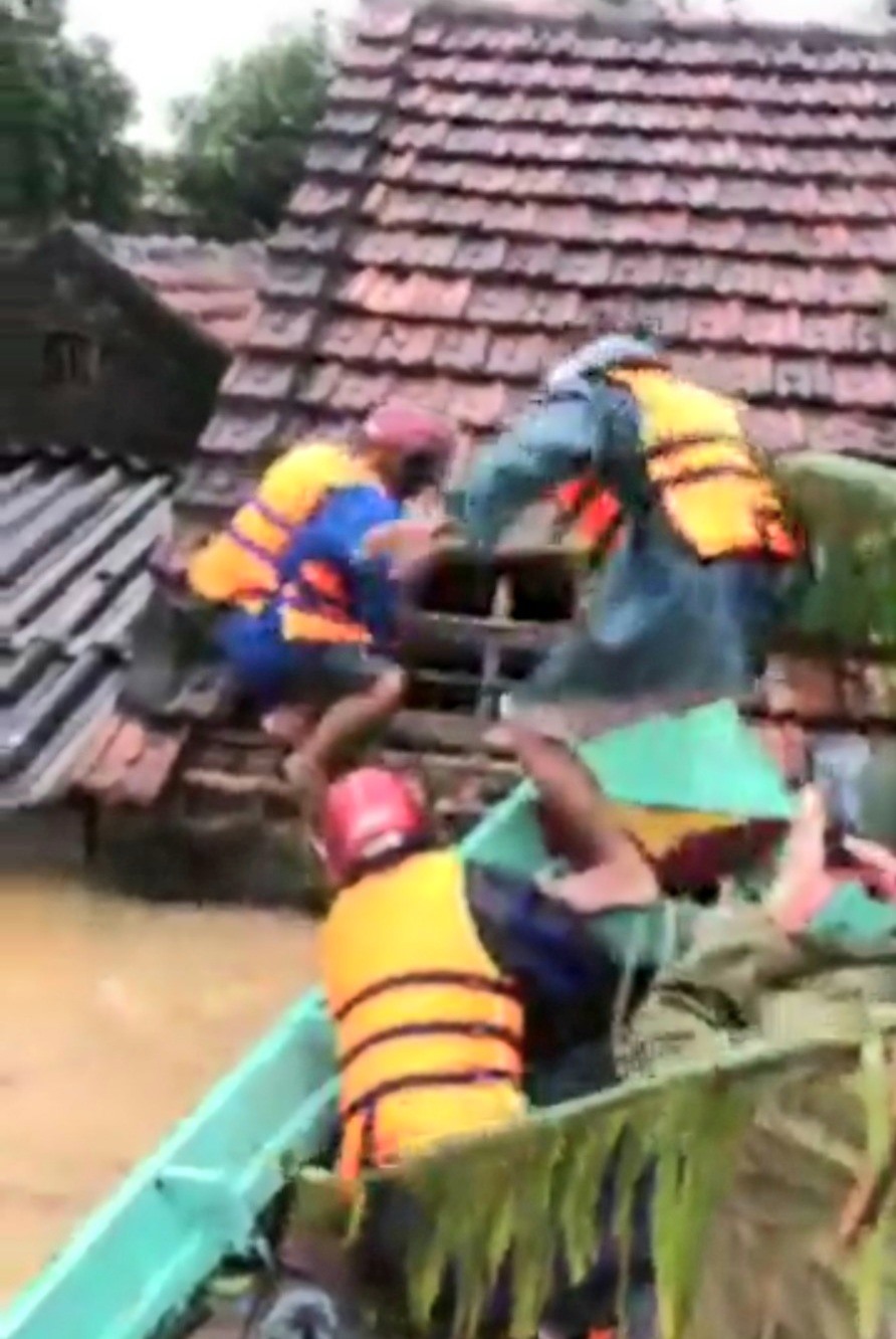 Ngư dân xã Hải Ninh tháo mái ngói cứu dân vùng lũ.