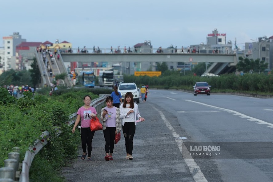 Giờ tan tầm, tình trạng người dân đi bộ tại làn dừng khẩn cấp trên cao tốc, chạy nhanh để băng qua đường vào giờ tan tầm trên tuyến cao tốc Hà Nội - Bắc Giang đoạn đi qua khu công nghiệp Vân Trung, tỉnh Bắc Giang.