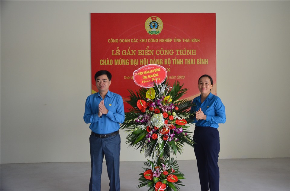 Ông Bùi Xuân Vinh - Chủ tịch LĐLĐ tỉnh Thái Bình  tặng hoa chúc mừng tại lễ gắn biển công trình. Ảnh Bá Mạnh