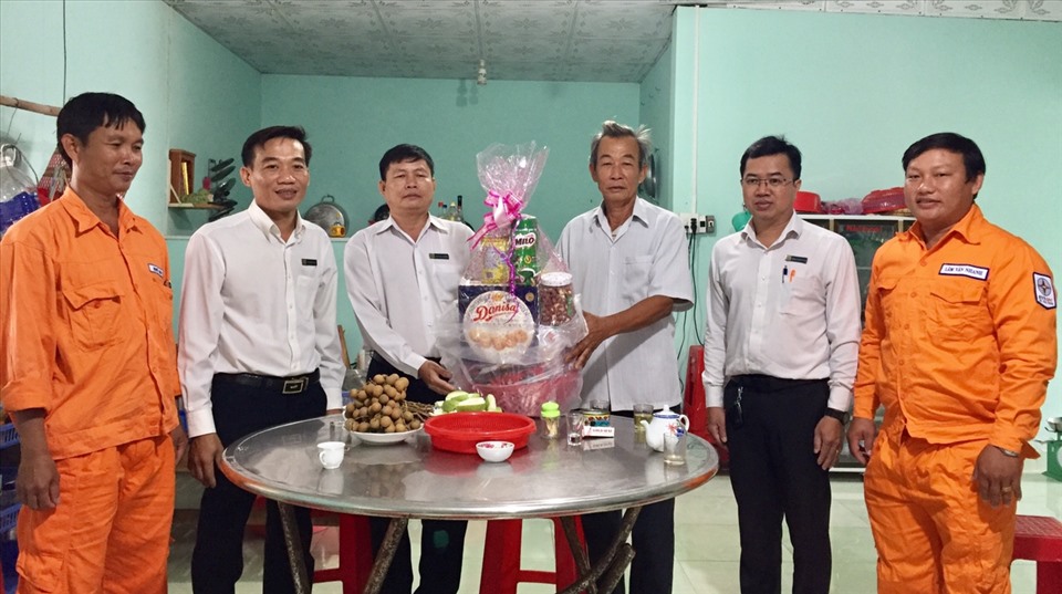 Đại diện Công đoàn Công ty Điện lực Trà Vinh cùng lãnh đạo và công nhân viên Điện lực Thị xã Duyên Hải thăm hỏi ông Lâm Nhi Hổ (thứ ba từ trái qua). Ảnh EVNSPC cung cấp.