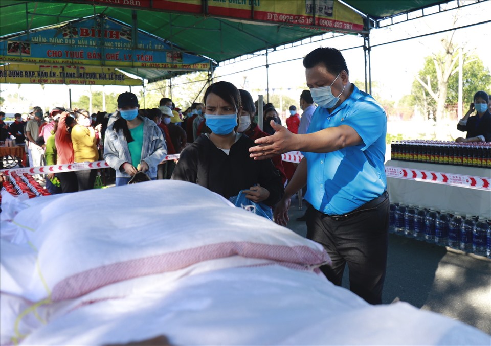 Lãnh đạo Công đoàn các Khu công nghiệp tỉnh Quảng Nam hướng dẫn người lao động mua sắm các mặt hàng thiết yếu. Ảnh: HL