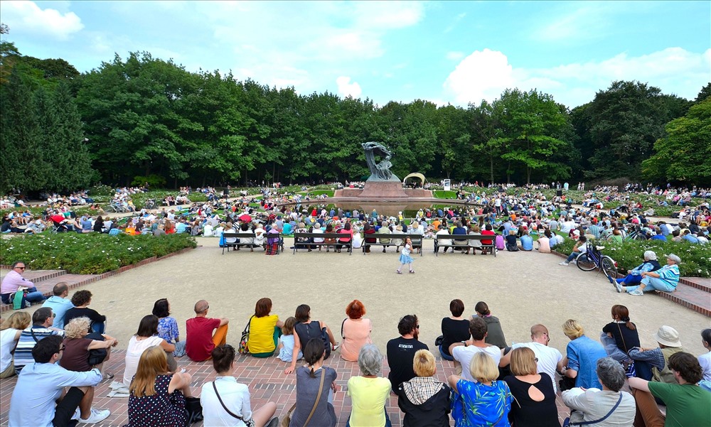 Nghe nhạc Chopin bên tượng đài Chopin tại Công viên Hoàng gia thủ đô Warszawa, Ba Lan.