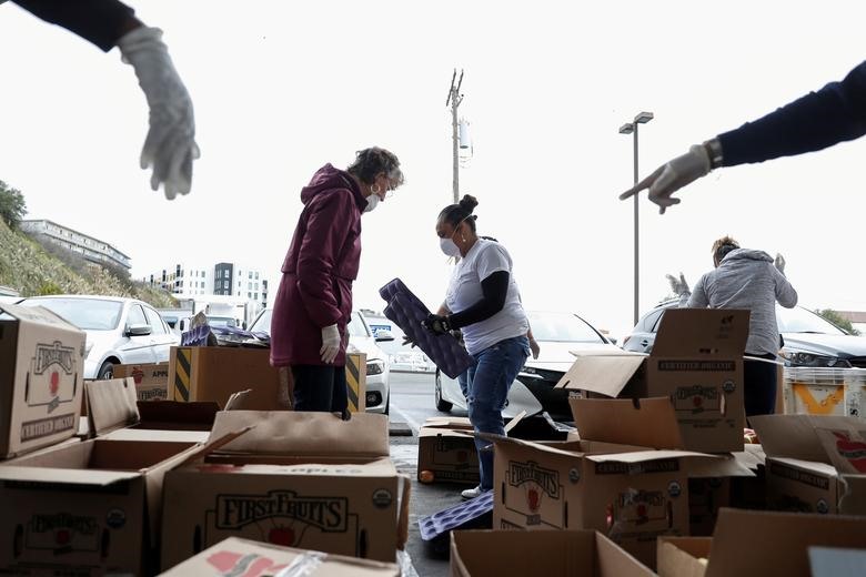 Tình nguyện viên đang phân loại táo tại kho thực phẩm San Francisco-Marin, ở San Francisco, California, ngày 16.3. Ảnh: Reuters