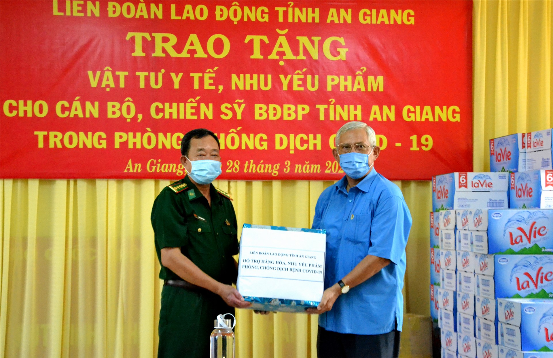 Chủ tịch LĐLĐ An Giang Nguyễn Thiện Phú trao hỗ trợ mì gói, cà phê hòa tan và nước tinh khiết cho lực lượng Bộ đội biên phòng An Giang. Ảnh: LT