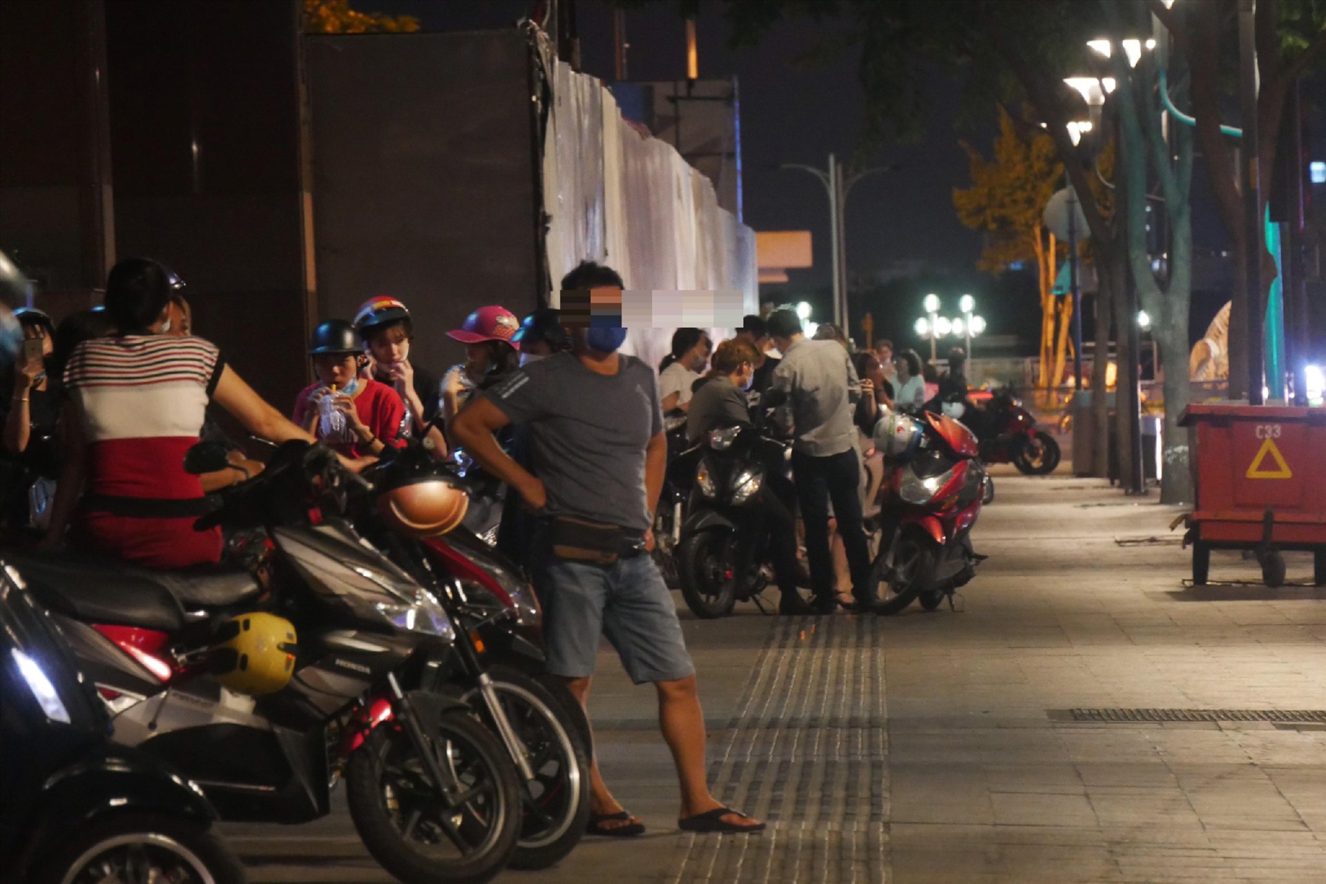 Tại phố đi bộ Nguyễn Huệ (quận 1) có rất nhiều nhóm người tập trung vui chơi, thư giãn, không giữ khoảng cách 2m theo quy định.