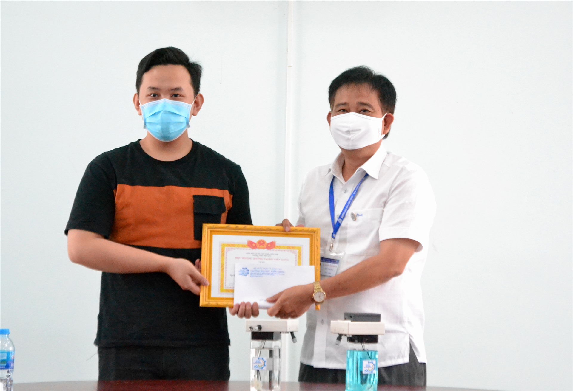 Tiến sĩ Nguyễn Tuấn Khanh (phải) khen thưởng đột xuất sinh viên Thái Minh Tín. Ảnh: LT