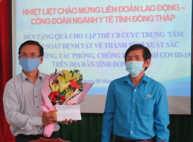 Ông Trần Hoàng Vũ, Chủ tịch LĐLĐ tỉnh Đồng Tháp (phải) trao quà hỗ trợ tại Trung tâm Kiểm soát bệnh tật tỉnh. Ảnh: L.H