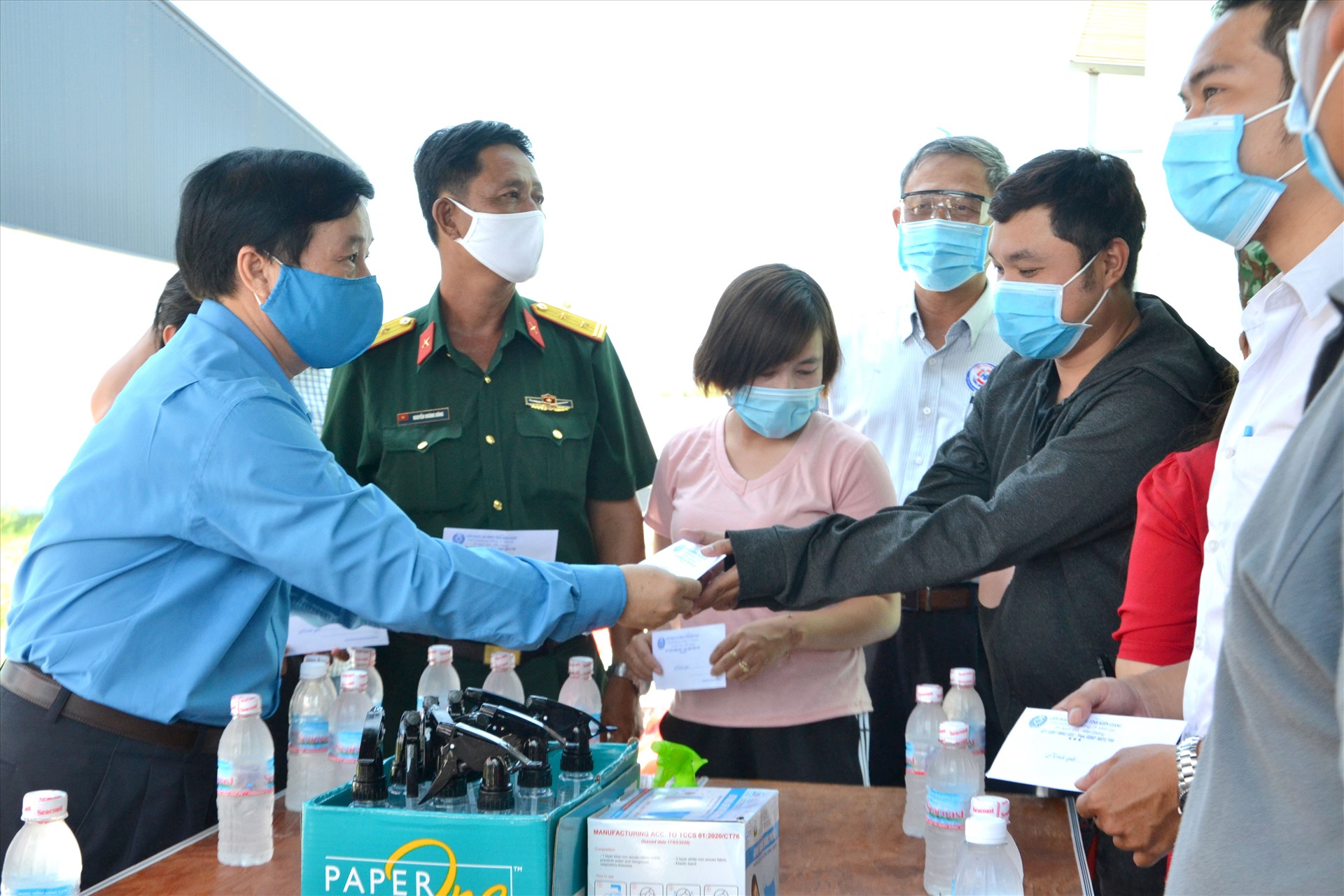 Ông Trần Thanh Việt trao hỗ trợ dụng cụ phòng chống dịch cho người lao động. Ảnh: LT