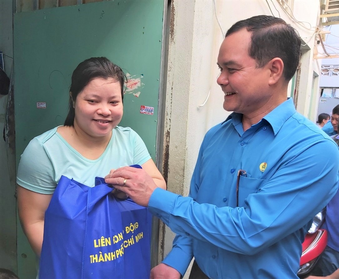 Chủ tịch Tổng LĐLĐVN Nguyễn Đình Khang tặng quà cho công nhân ở tại khu nhà trọ của gia đình bà Trần Thị Hà. Ảnh Nam Dương