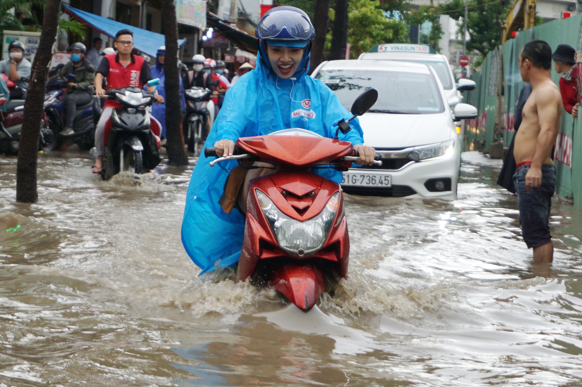 Người dân vất vả chạy xe máy qua đoạn ngập trên đường Nguyễn Hữu Cảnh (quận Bình Thạnh). Đây là “rốn” ngập ở TPHCM trong nhiều năm qua.  Ảnh: Minh Quân