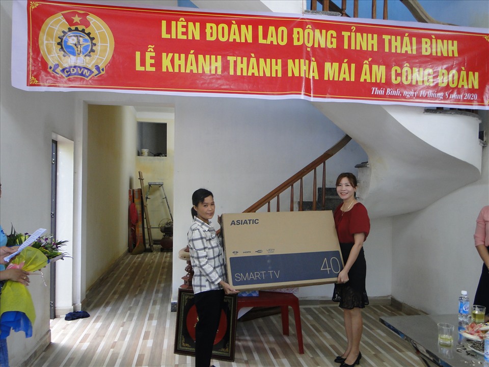 Bà Nguyễn Hoàng Ánh Nguyệt đại diện cho lãnh đạo công ty trao quà cho đoàn viên Bùi Thị Lành. Ảnh: B.Mạnh