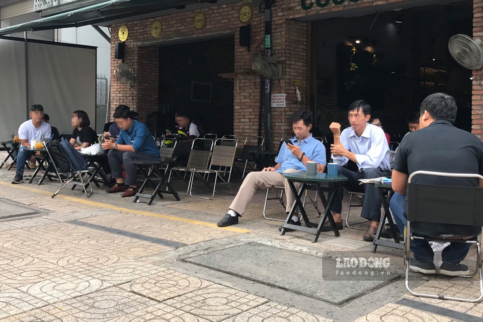 Người dân không đeo khẩu trang và không giữ khoảng cách an toàn tại một quán cà phê trên đường Trần Hưng Đạo (quận 1). Ảnh: Thanh Vũ