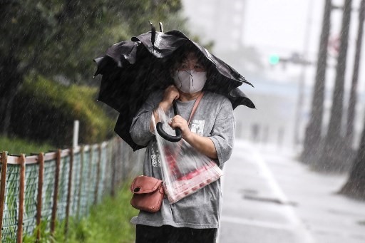 Người phụ nữ đi bộ dưới cơn mưa lớn khi bão Haishen đang đổ bộ ở thành phố Kagoshima, tỉnh Kagoshima, Nhật Bản. Ảnh: AFP