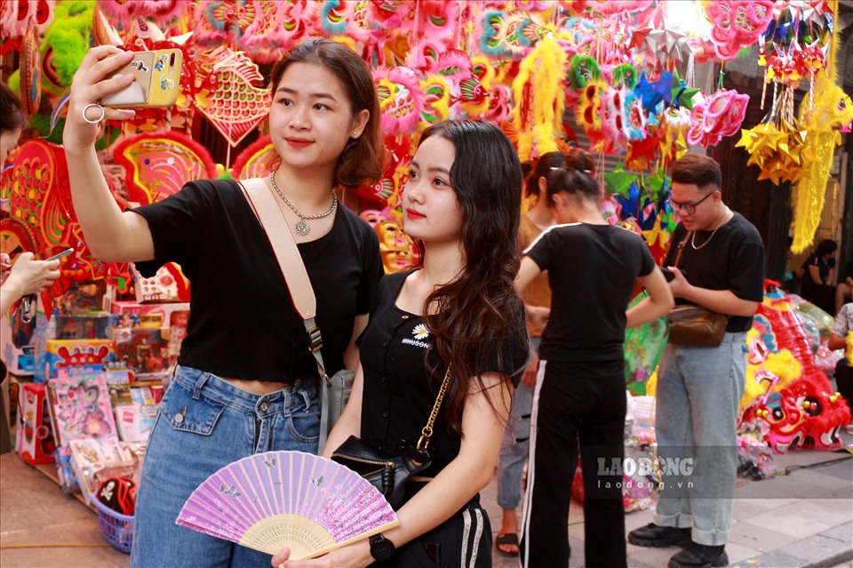 Ở một góc khác, 2 bạn trẻ đang tự chụp hình sefie trước khi mua đồ về trang trí cho ngày Tết Trung thu.