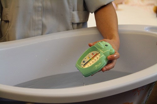 Kiểm tra nhiệt độ nước để đảm bảo sức khoẻ khi tắm cho bé vào mùa đông. Ảnh: GG