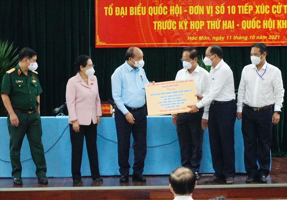 Chủ tịch nước Nguyễn Xuân Phúc tặng quà cho huyện Hóc Môn.  Ảnh: Minh Quân