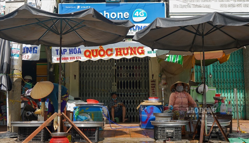 Người dân bày bán thực phẩm ngoài lộ, phía trước chợ. Ảnh: Minh Ánh