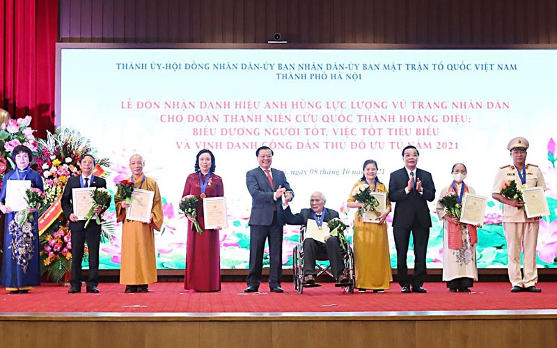 Bà Phan Thị Bính (Mặc áo dài vàng) nhận danh hiệu công dân Thủ đô ưu tú năm 2021. Ảnh: Viết Thành