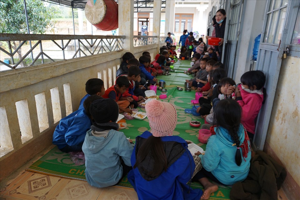 Bữa cơm trưa vội vã trải ra trên chiếu của hàng chục em học sinh ở điểm trường Kon Du. Ảnh T.T