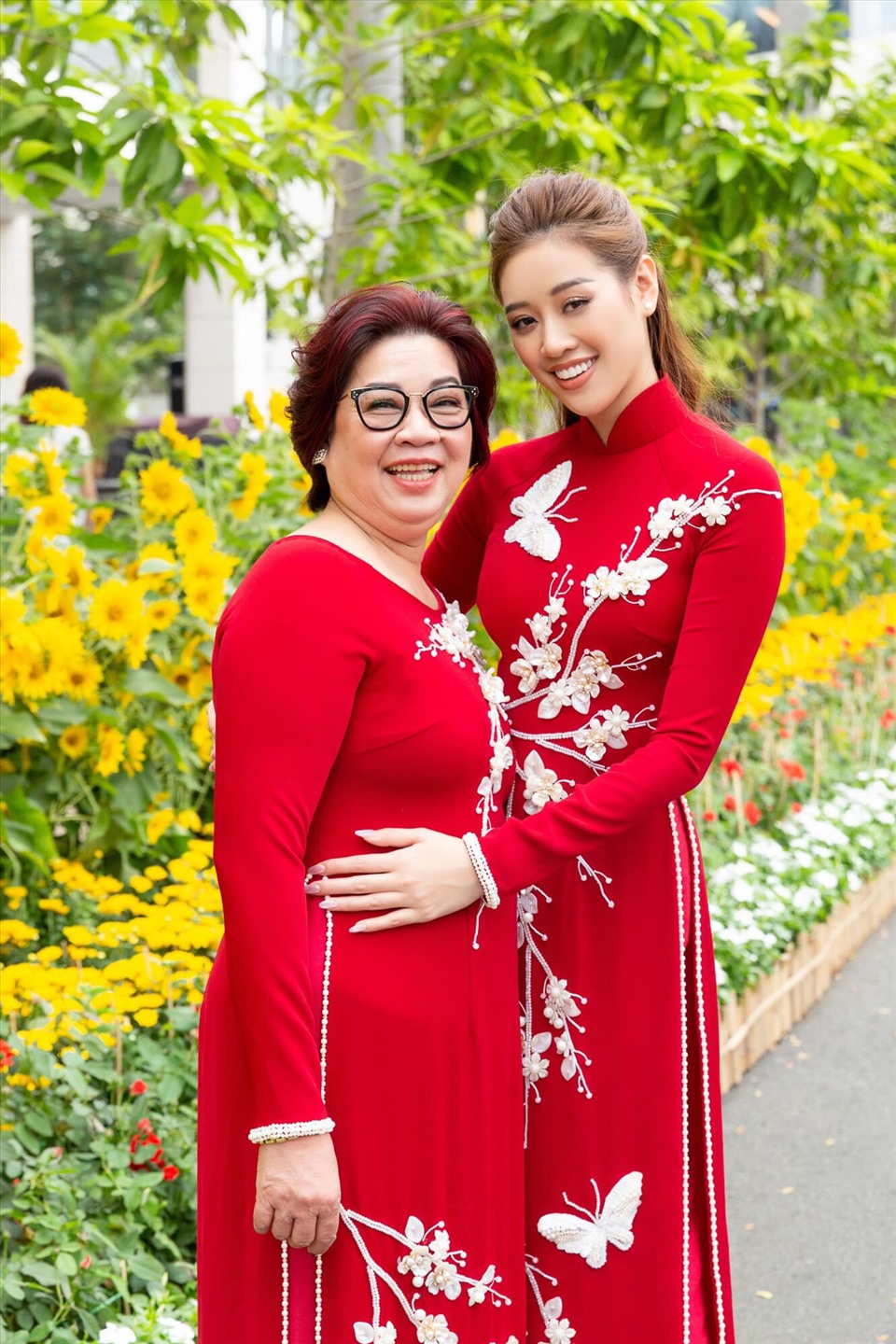 Hoa hậu Khánh Vân xúng xính diện áo dài đỏ cùng mẹ. Hiện cô vẫn đang tích cực chuẩn bị những kỹ năng để dự thi Miss Universe. Ảnh: NVCC.