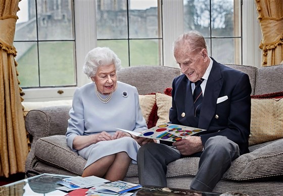 Nữ hoàng Elizabeth II và Hoàng thân Philip, Công tước xứ Edinburgh xem tấm thiệp do chắt của họ - các con của Hoàng tử William - tặng nhân kỷ niệm ngày cưới  tại lâu đài Windsor tháng 11.2020. Ảnh: Điện Buckingham/AFP.