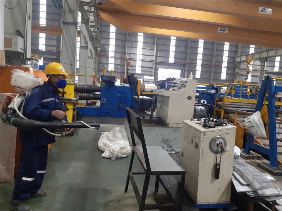 Doanh nghiệp tại Nghệ An tiến hành phun khử trùng các thiết bị, máy móc. Ảnh: QĐ