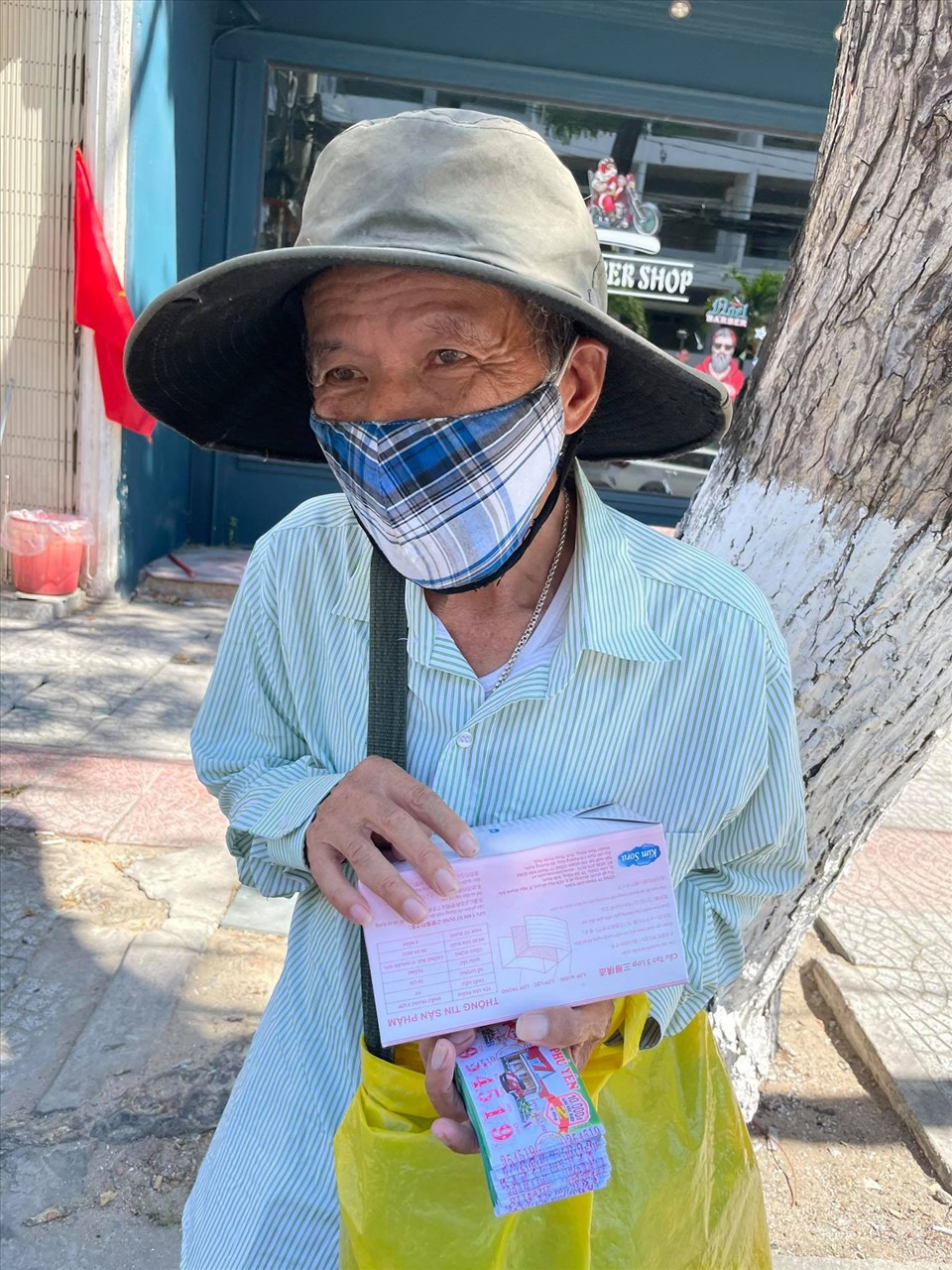 Một người bán vé số trên đường Hải Phòng, thành phố Đà Nẵng nhận được khẩu trang của nhó thiện nguyện anh Cao Quang Mẫn. Ảnh: Bảo Hoàng
