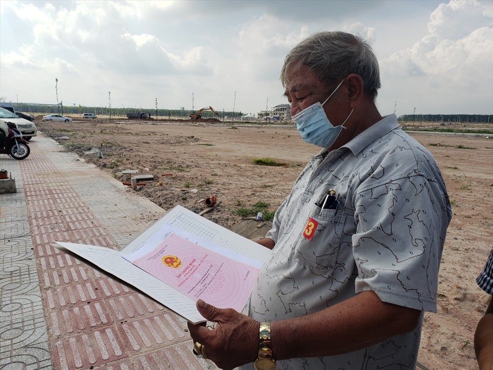 Ông Huỳnh Ngọc Ảnh nhận “sổ đỏ” tại khu tái định cư Lộc An - Bình Sơn. Ảnh: Hà Anh Chiến
