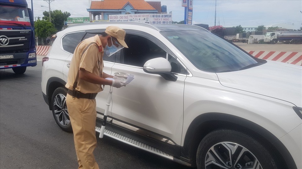 Cảnh sát giao thông kiểm tra giấy tờ lưu thông của xe ô tô trên đường Mỹ Phước Tân Vạn đoạn qua thành phố Thủ Dầu Một.