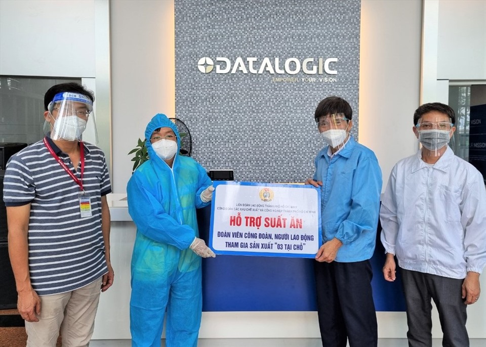 Ông Phạm Văn Hiền (thứ hai từ trái qua), trao biển tượng trưng tiền hỗ trợ bữa ăn cho công nhân “3 tại chỗ” của Công ty datalogic. Ảnh: Nam Dương