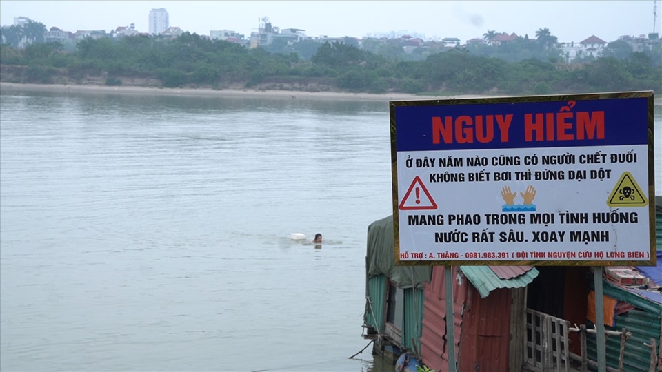 Biển cảnh báo nguy hiểm được cắm dọc bờ sông. Ảnh: PV.