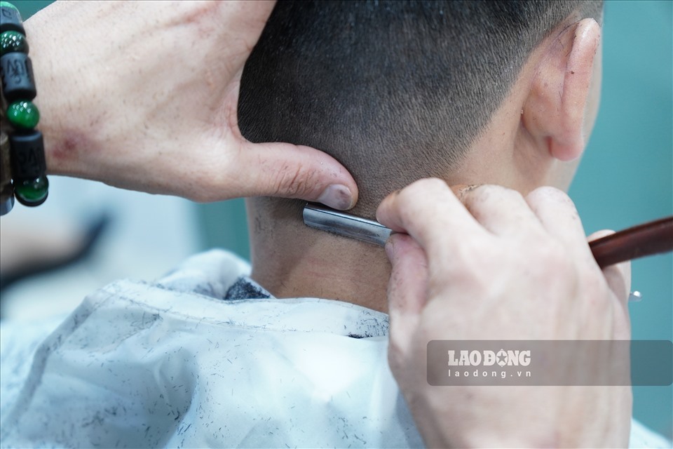 Nhân viên cắt tóc cẩn thận từng động tác, chăm sóc cho khách hàng. Ảnh: PV.