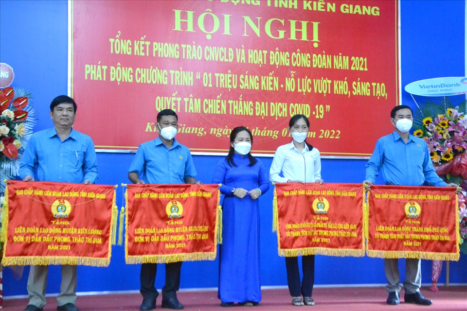 Chủ tịch LĐLĐ tỉnh Kiên Giang Trương Thanh Thúy tặng cờ cho 4 đơn vị đạt thành tích xuất sắc năm 2021. Ảnh: LT