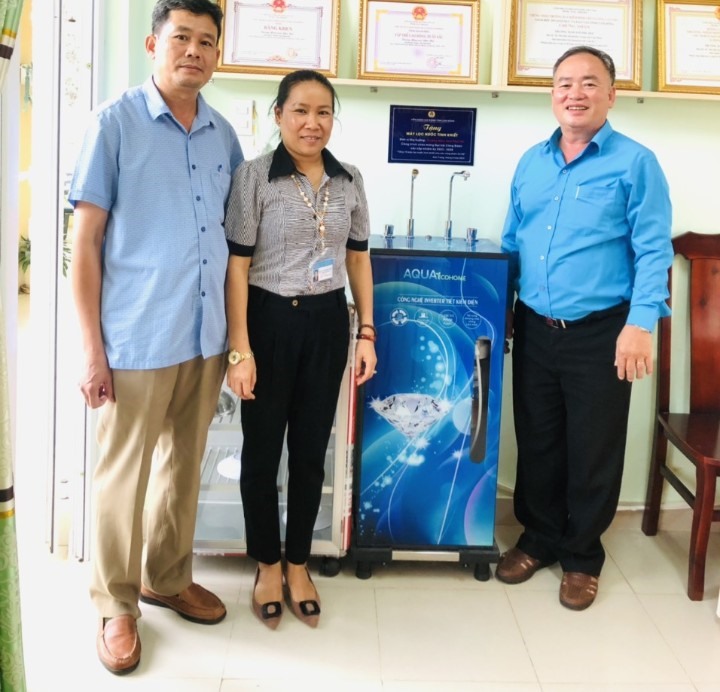 Ông Lưu Văn Lợi - Chủ tịch LĐLĐ huyện Đức Trọng, Lâm Đồng (bên phải) trao tặng máy lọc nước tinh khiết cho Trường Mầm non Phua Hội. Ảnh: Thúy Hiệp.
